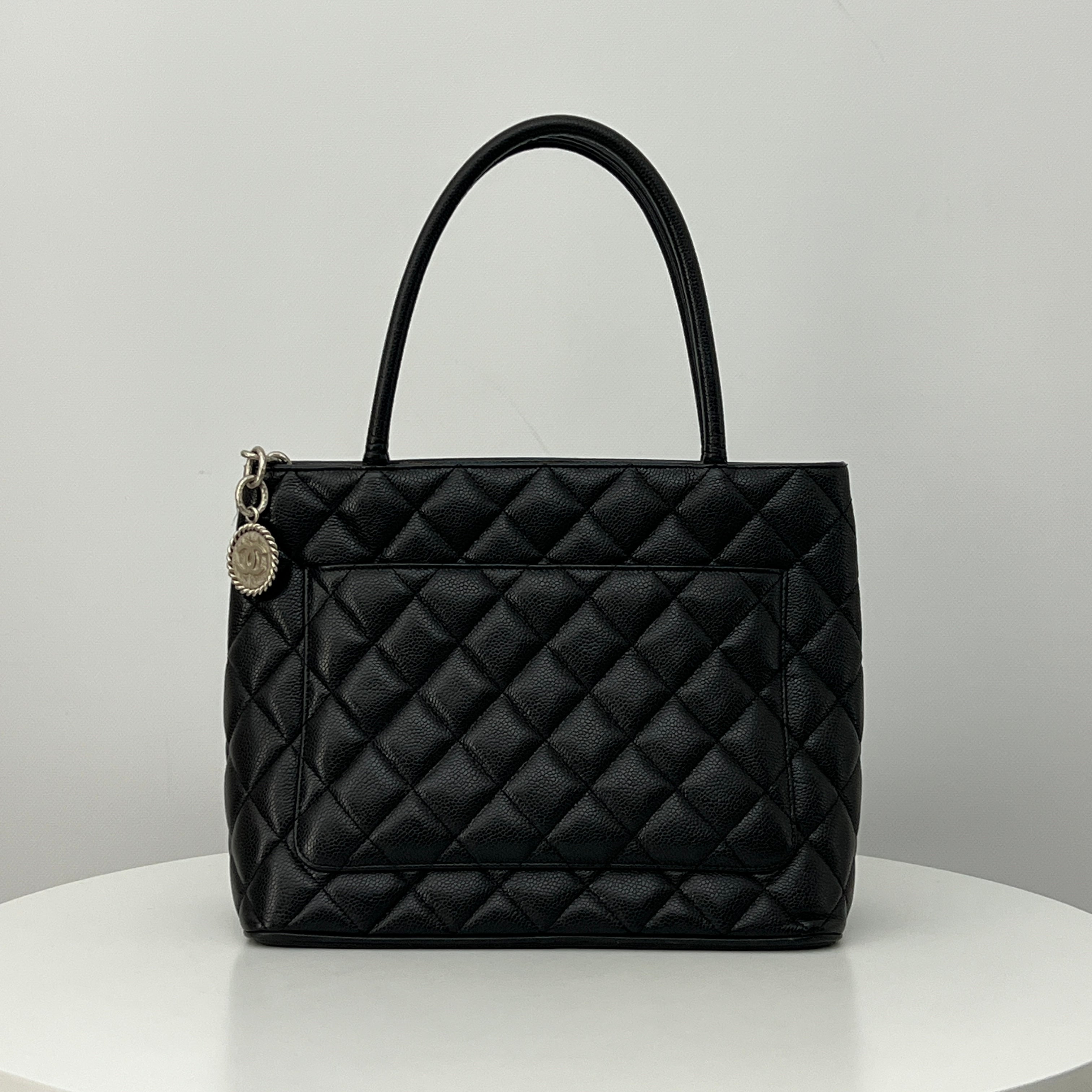 CHANEL Medallion bag in black caviar leather