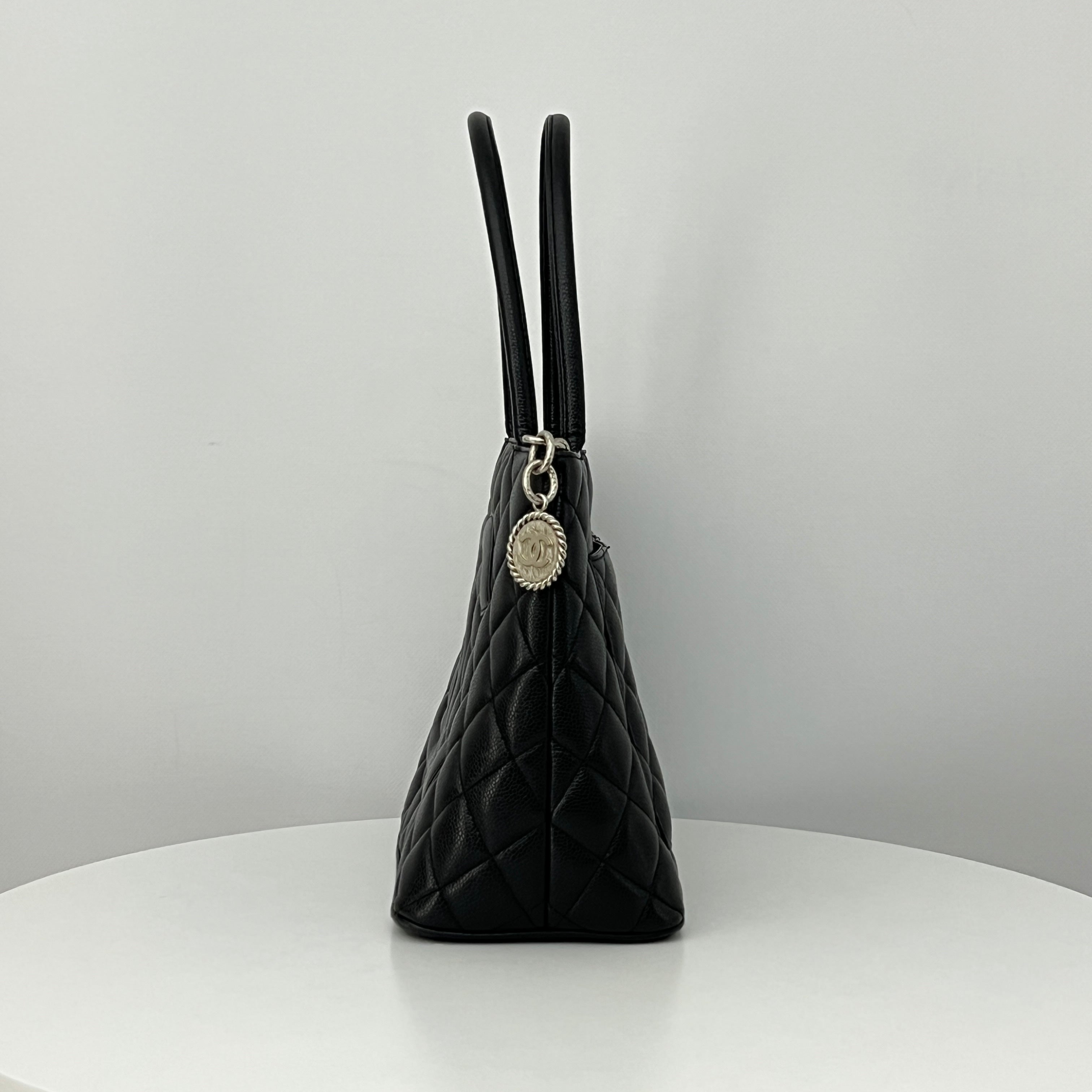 CHANEL Medallion bag in black caviar leather