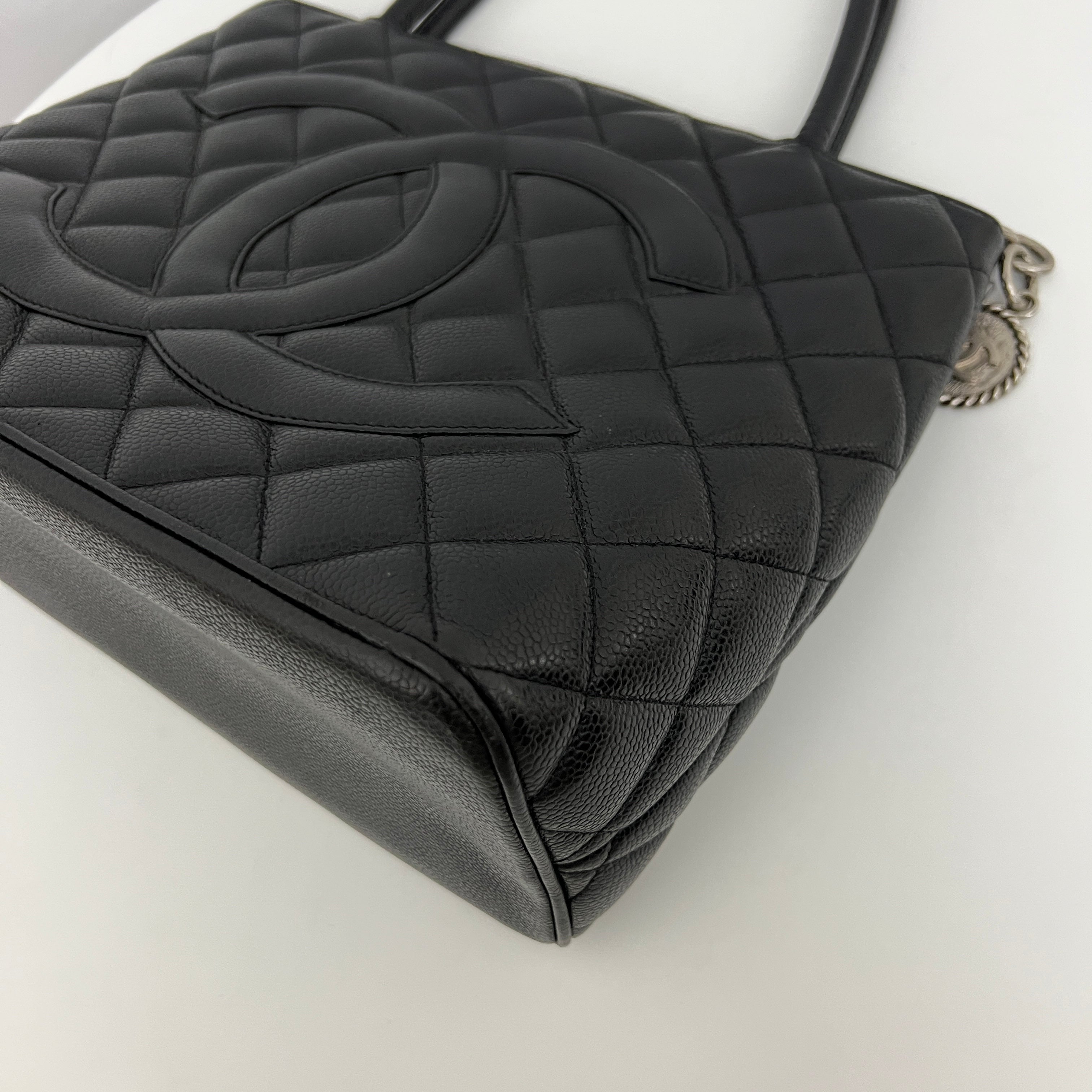 CHANEL Medallion bag in black caviar leather