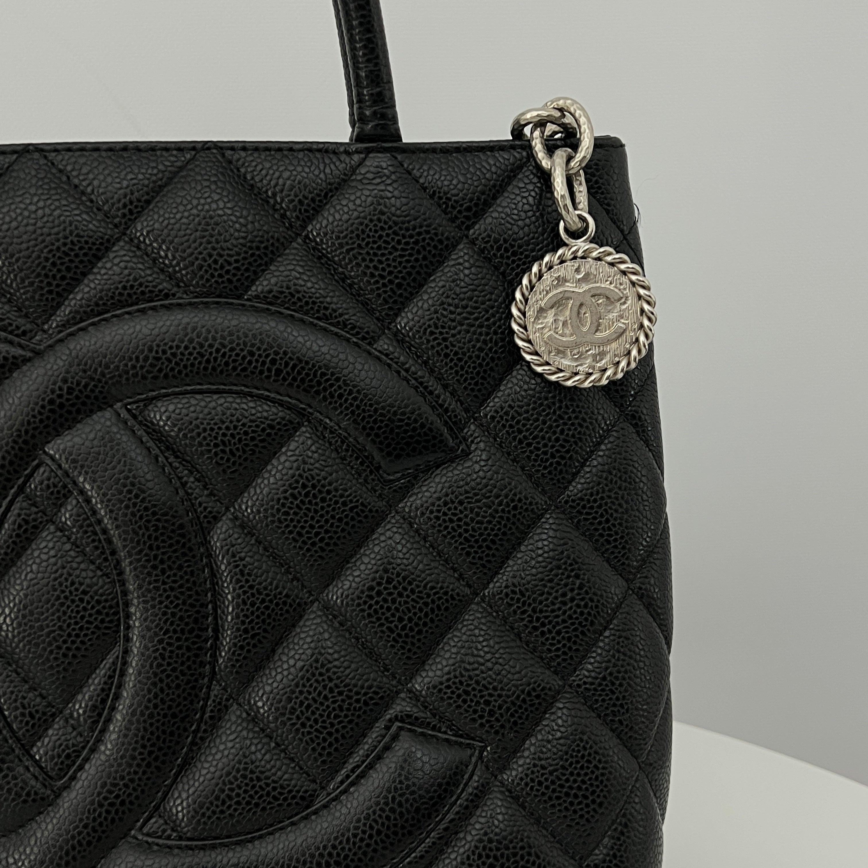 CHANEL Medallion bag in black caviar leather