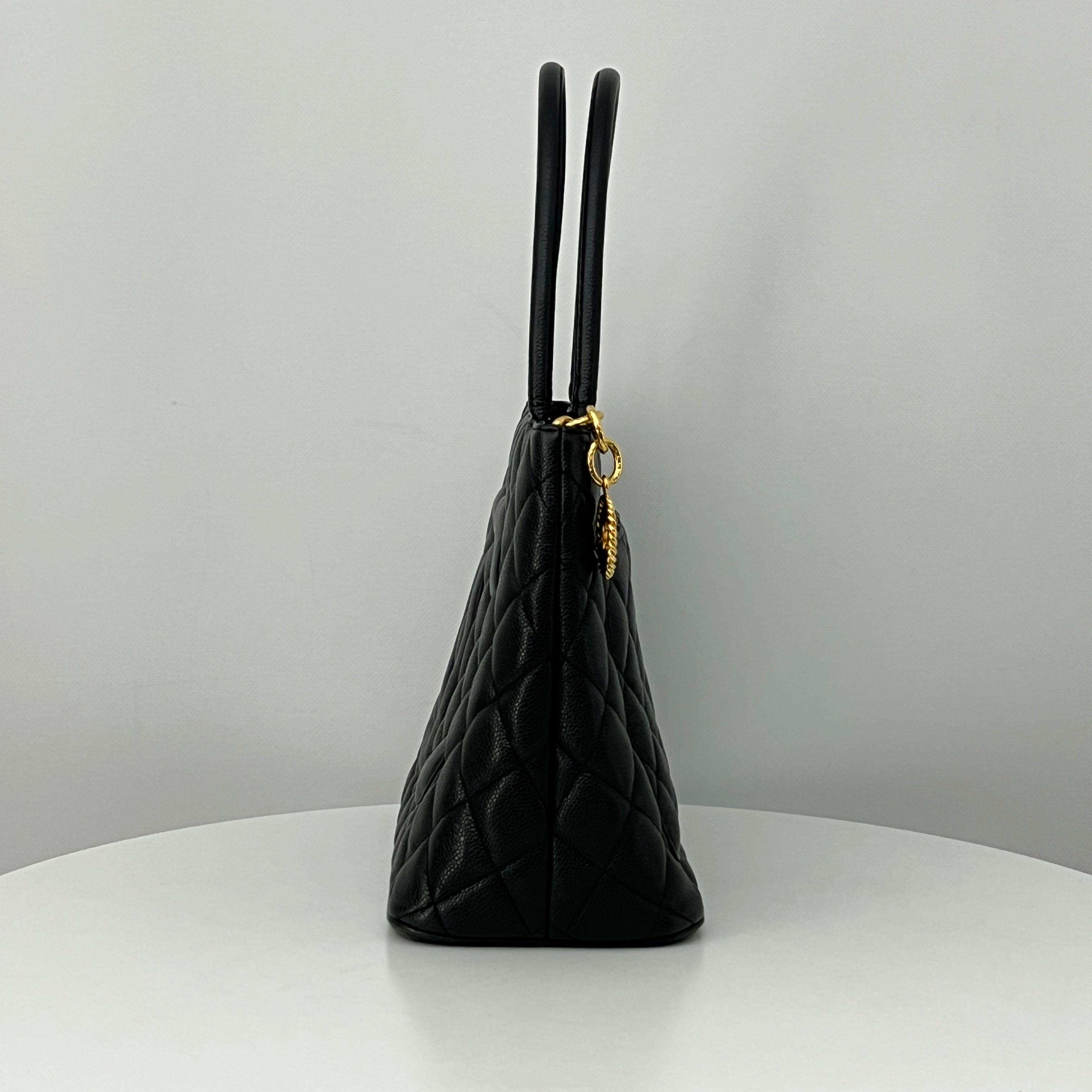 CHANEL Medallion bag in black caviar leather
